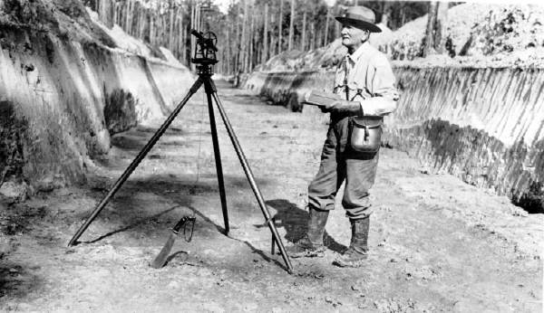 H.E. Lagergren surveying canal between Lakes Sampson and Crosby