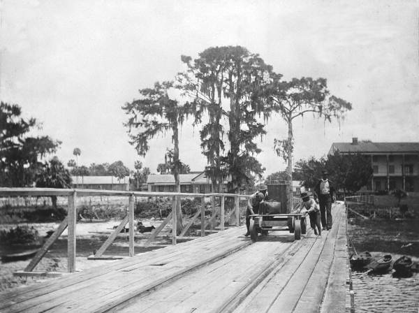 Men moving luggage on the steamship dock at the Brock House hotel - Enterprise, Florida