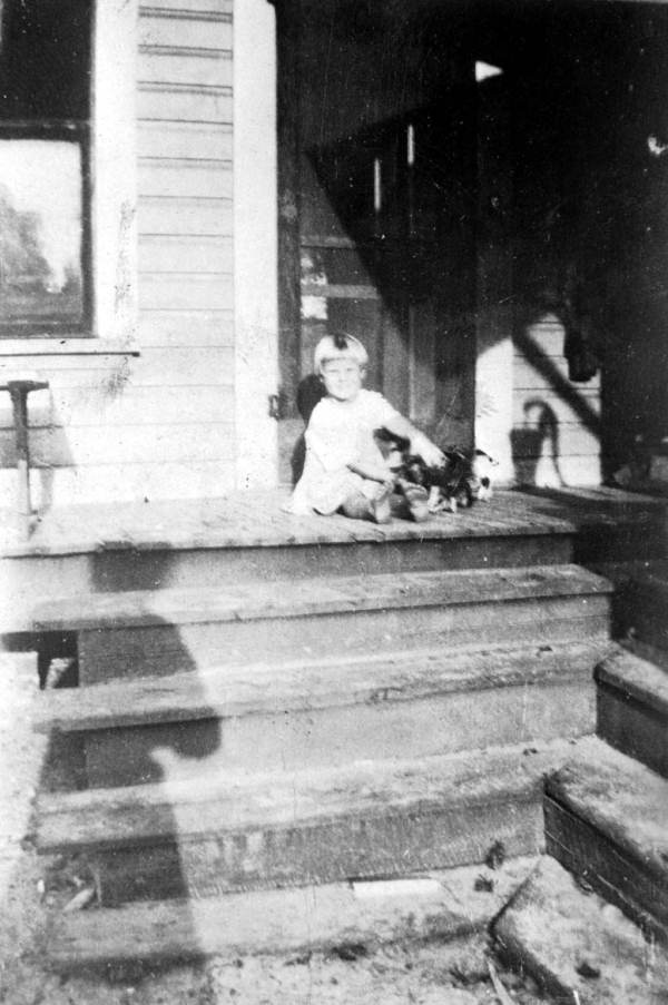 Turner child, with kittens, on the steps of the Turner home.
