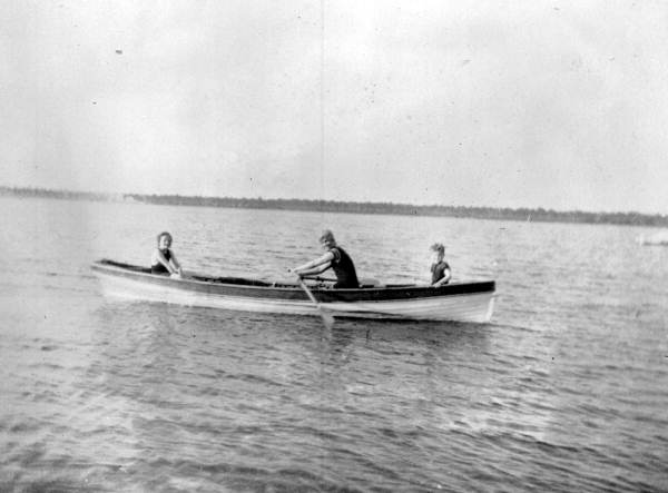 Mrs. Ahern rowing a boat with her children aboard on Crooked Lake - Babson Park, Florida