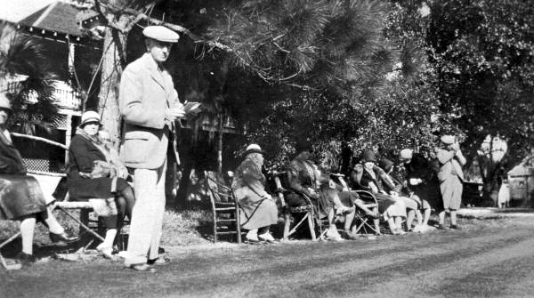 Spectators gathered on benches to watch some golf - Fort George Island, Florida