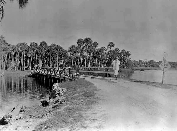 Woman crossing bridge over the Pithlachascotee River, New Port Richey.