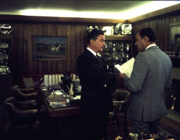 Governor Claude Kirk, right, talking with an unidentified man at a horse farm