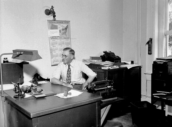 Man sitting at desk in Dept. of State office