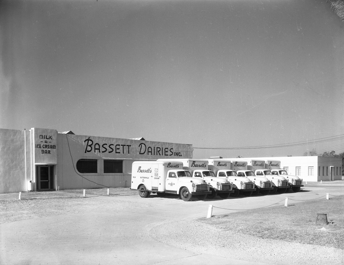Delivery trucks parked in front of Bassett Dairies building