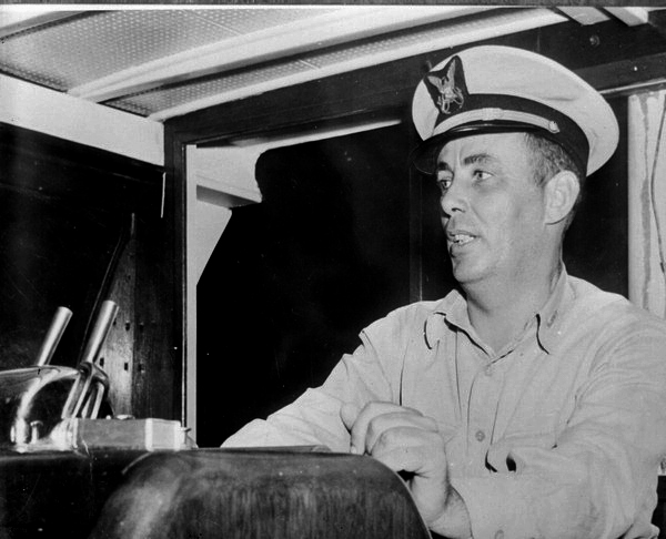 Naval officer at the helm of a ship