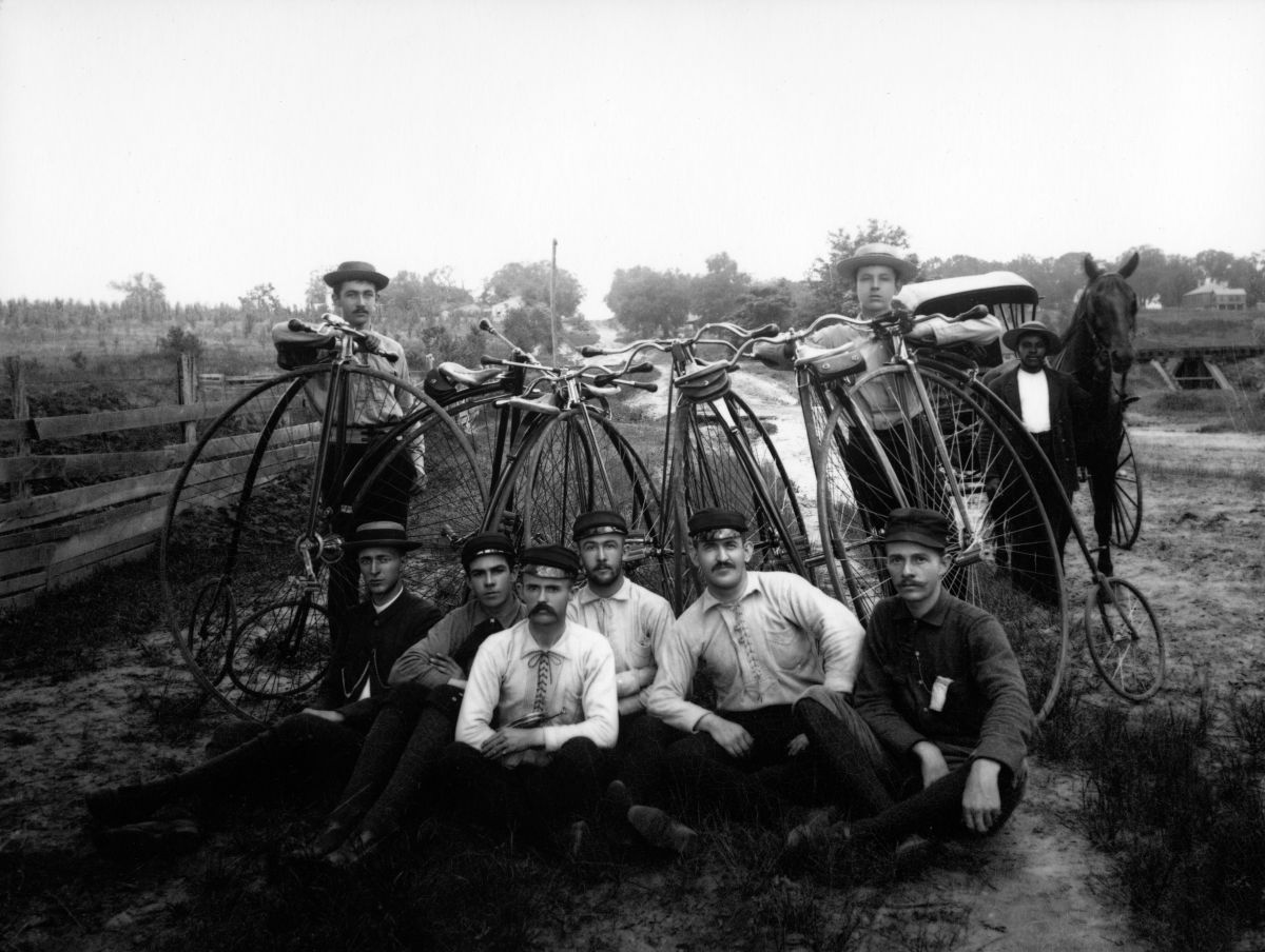 Eight young men with Penny-Farthing bicycles, ca. 1890