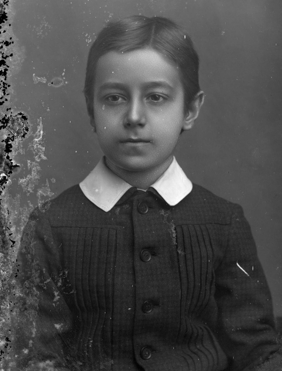 Portrait of a seated boy.