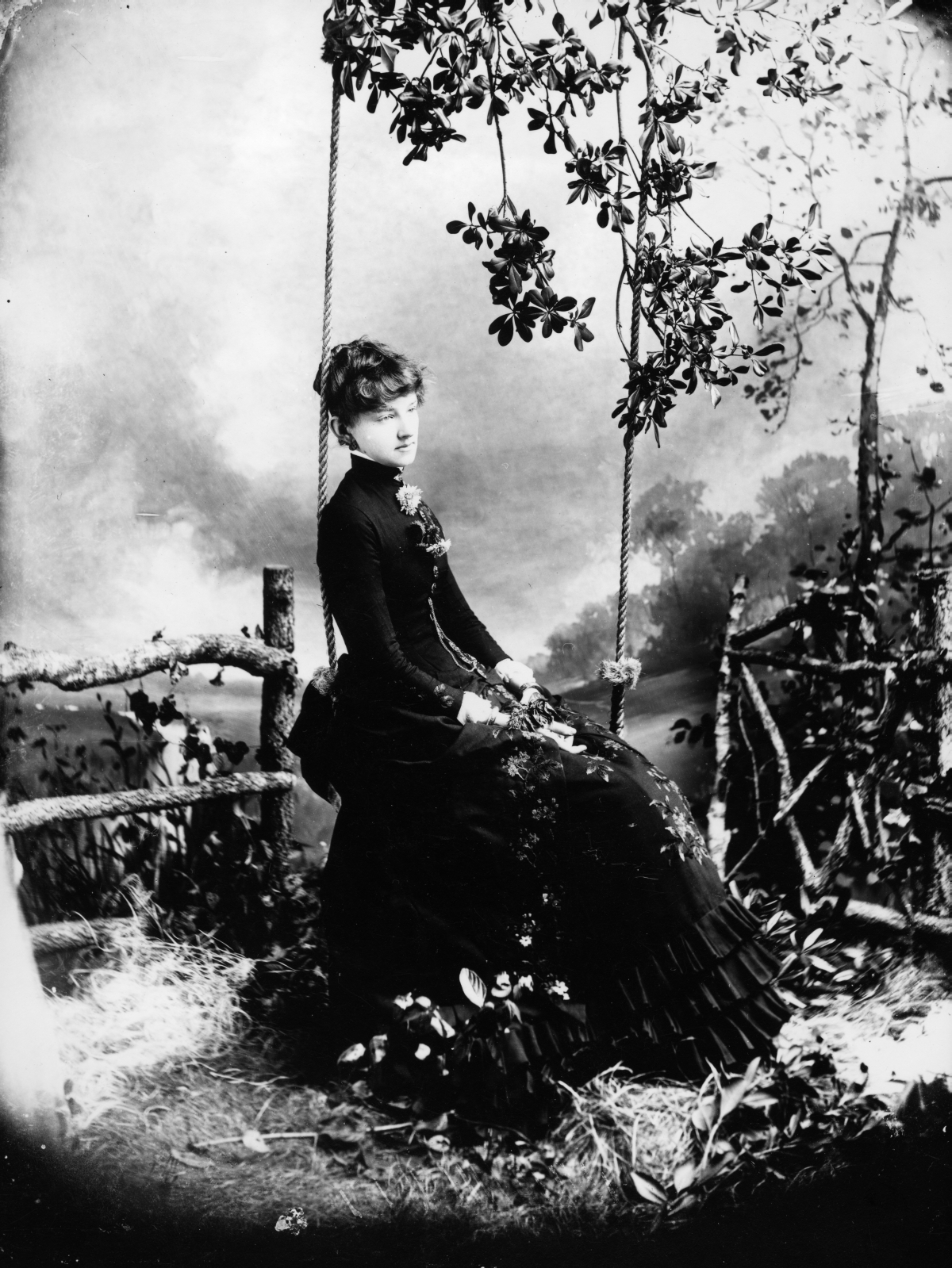 Young woman seated in swing