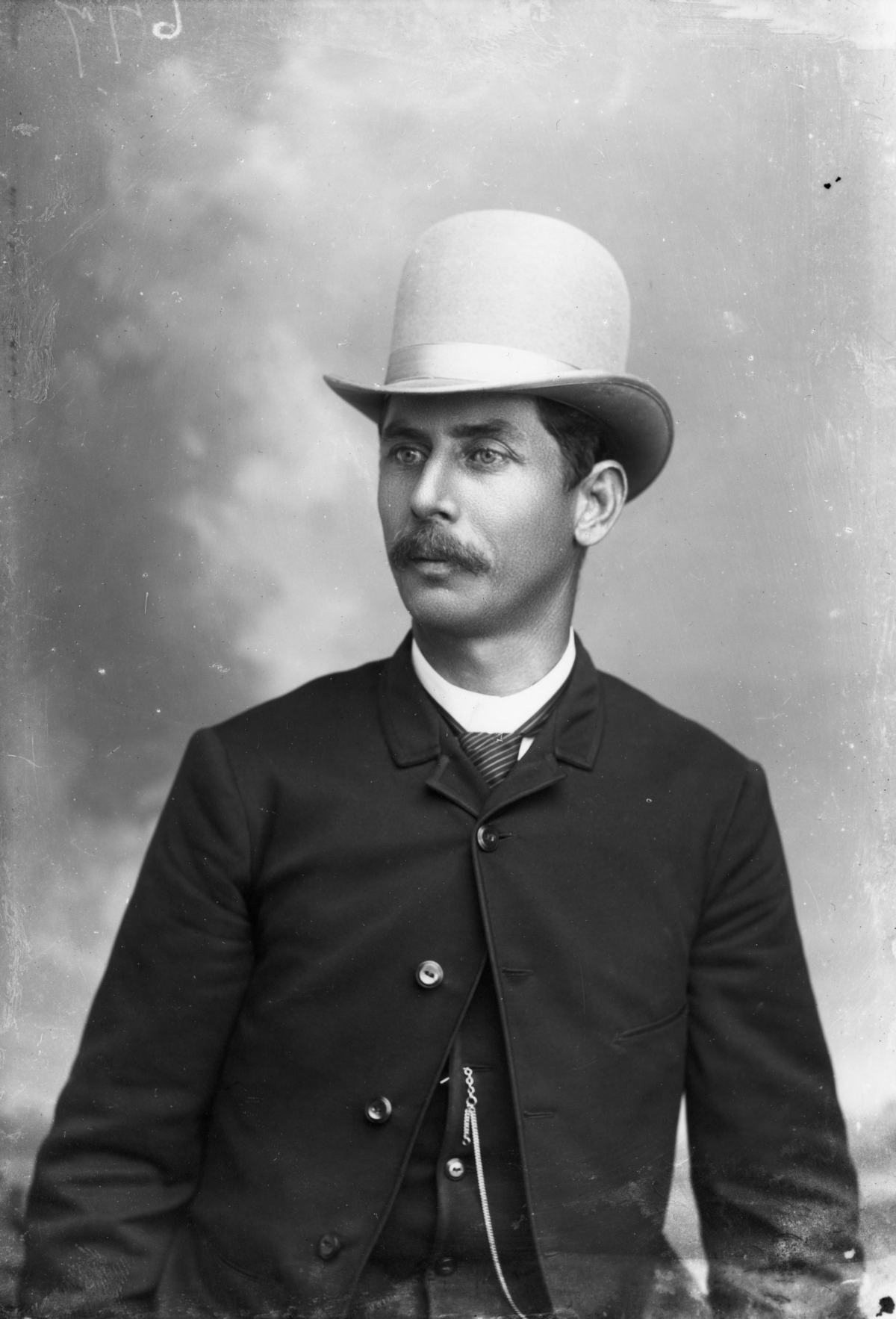 Mustached man in a bowler hat.