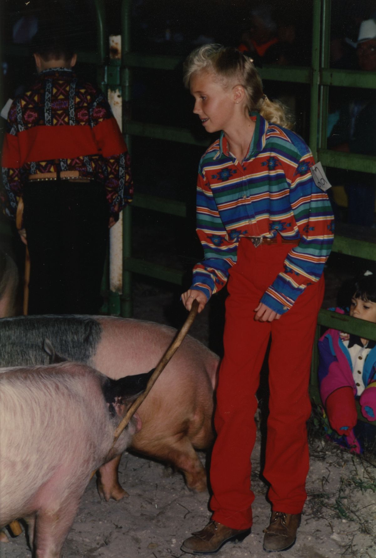 Girl with pigs at the Glades County Youth Livestock Show in Moore Haven.