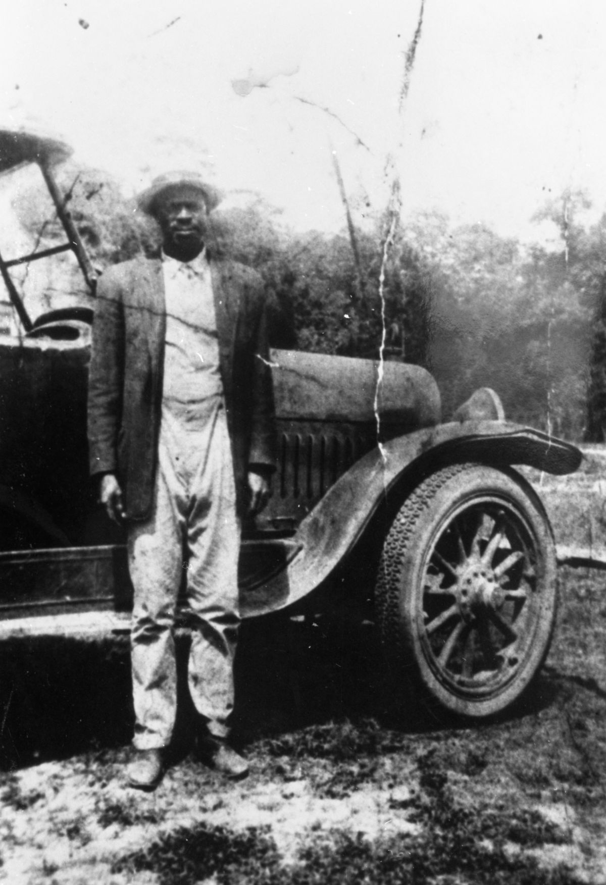 Charlie H. Moore beside car - Lovett, Florida