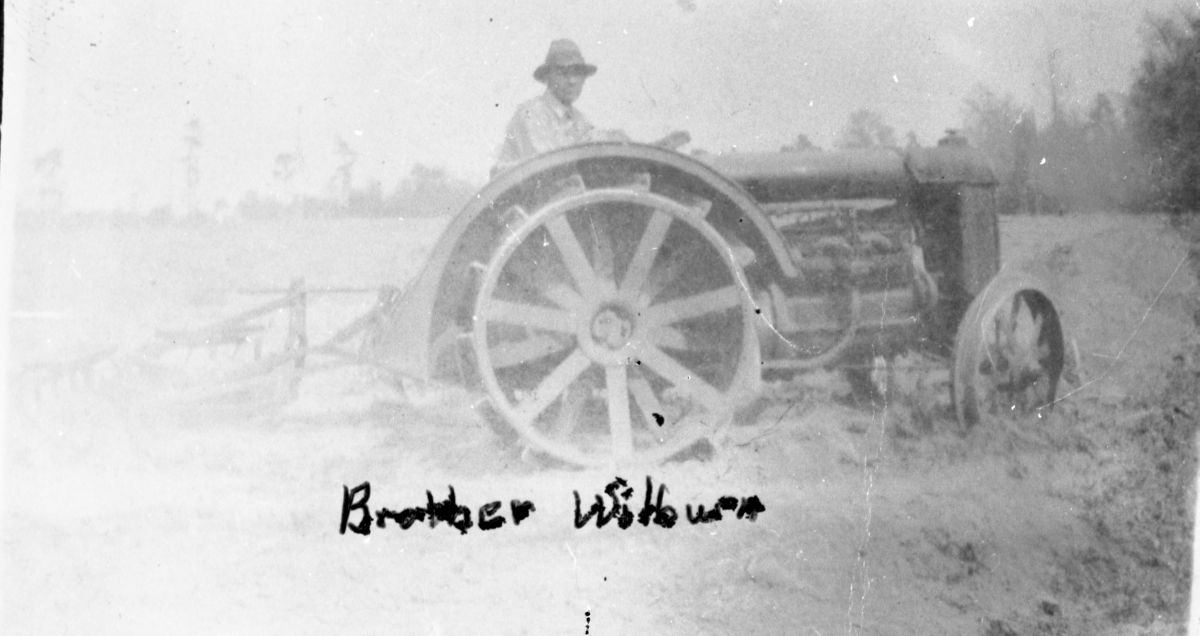 Wilburn Cathledge driving a tractor - Madison, Florida.
