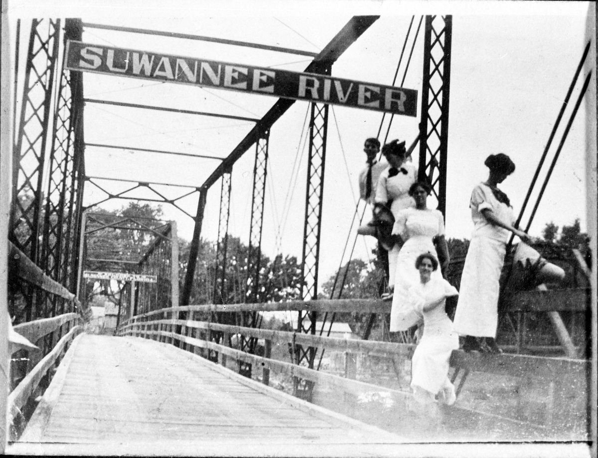Group posed on railing of Hillman Bridge - Ellaville, Florida