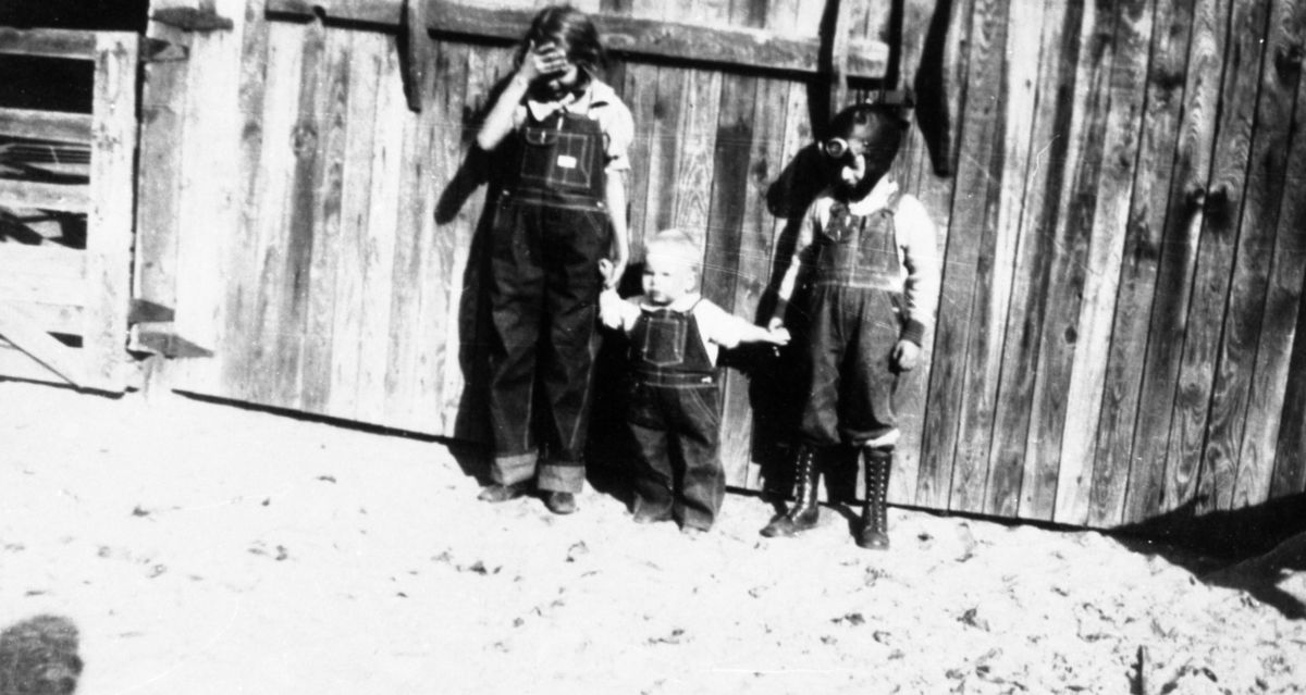 Florence Eloise Littleton standing with her two brothers in front of garage - Madison, Florida