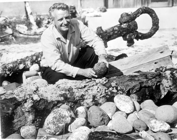 Art McKee posing with ballast on mock shipwreck display - Plantation Key, Florida