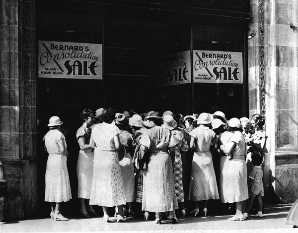 Women wainting for Bernard's dress shop doors to open on sale day