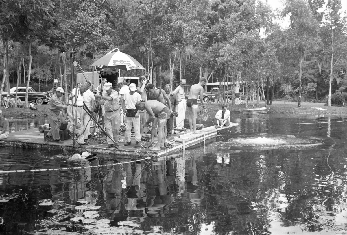 Crew working from floating platform during filming of the "Revenge of the Creature" movie at Silver Springs.