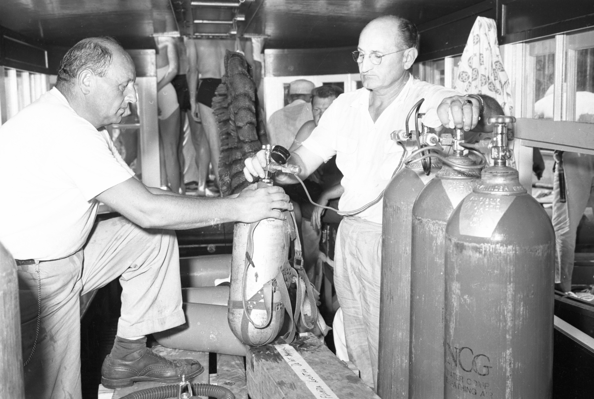 Crew filling air tanks on location during filming of the "Revenge of the Creature" movie at Silver Springs.