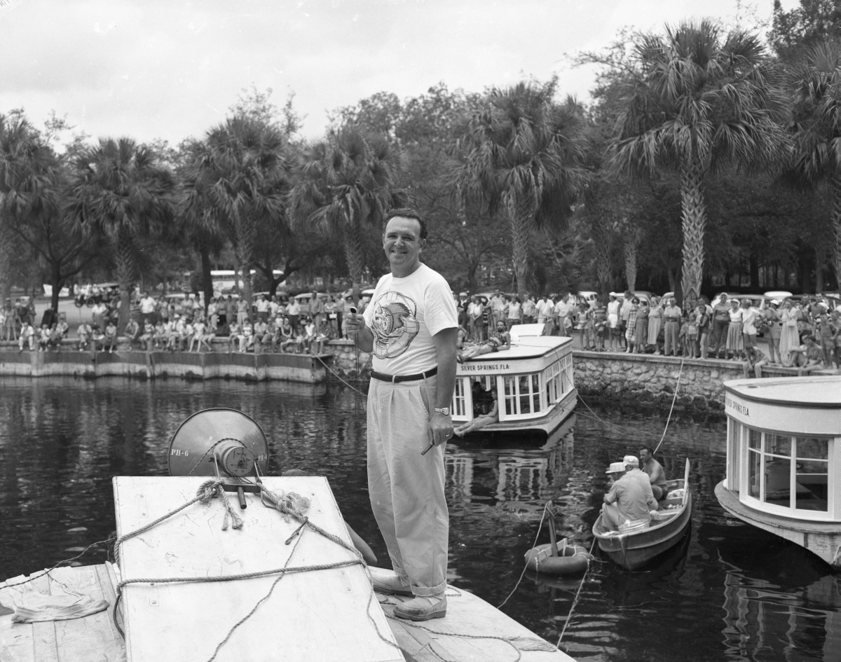 Director George Sidney on boat while filming "Jupiter's Darling" at Silver Springs.