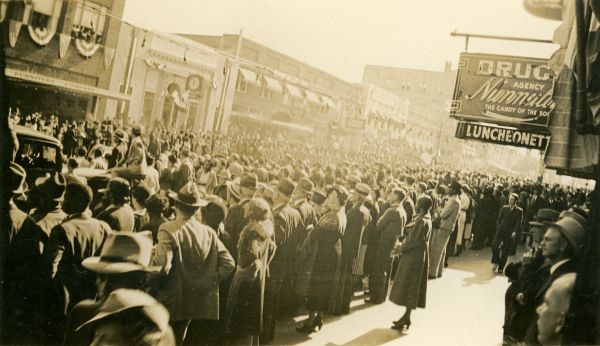 Crowds watching the centennial celebration parade on Monroe St. in downtown Tallahassee.