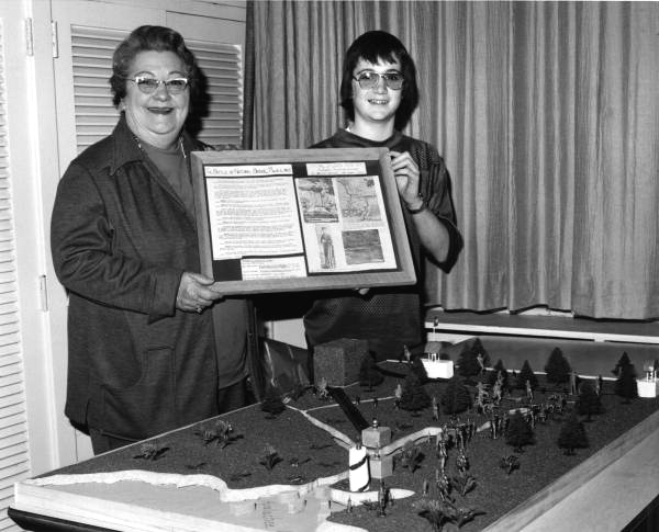 Eighth grader Barry Brooks with his Social Studies Fair exhibit on the Battle of Natural Bridge