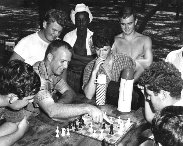 Neighborhood Youth Corps counselor Lane Goodson playing chess with youth in the Withlacoochee State Forest.