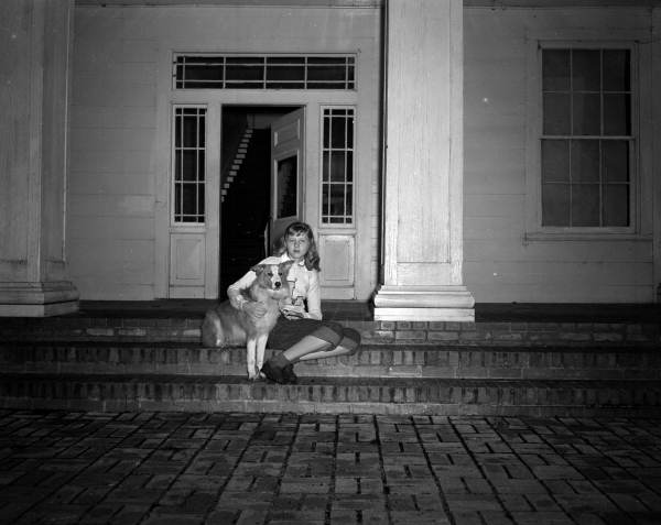 Young woman posing with dog in front of Gregory House at Torreya State Park - Rock Bluff, Florida