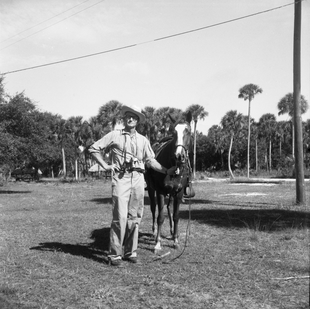 Irvin Peithmann standing next to a horse