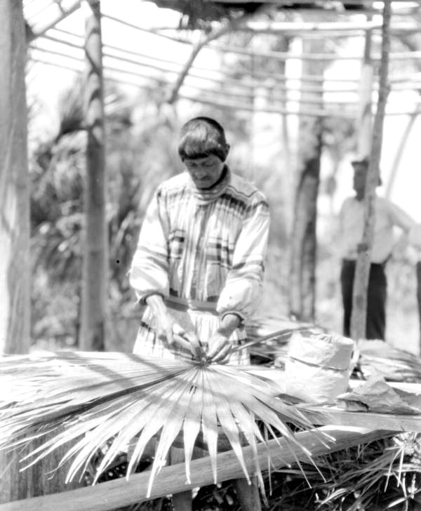Charlie Cypress hammering palm leaf for roof