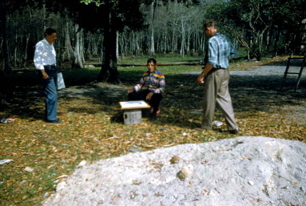 Men studying mound