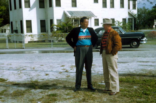 Seminole Indian men in front of a house at the Dania Seminole Indian Reservation