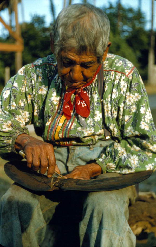 Seminole Indian Charlie Micco stitching some leather