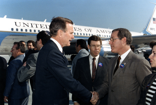 Secretary of State Jim Smith greeting Vice-President George Bush.