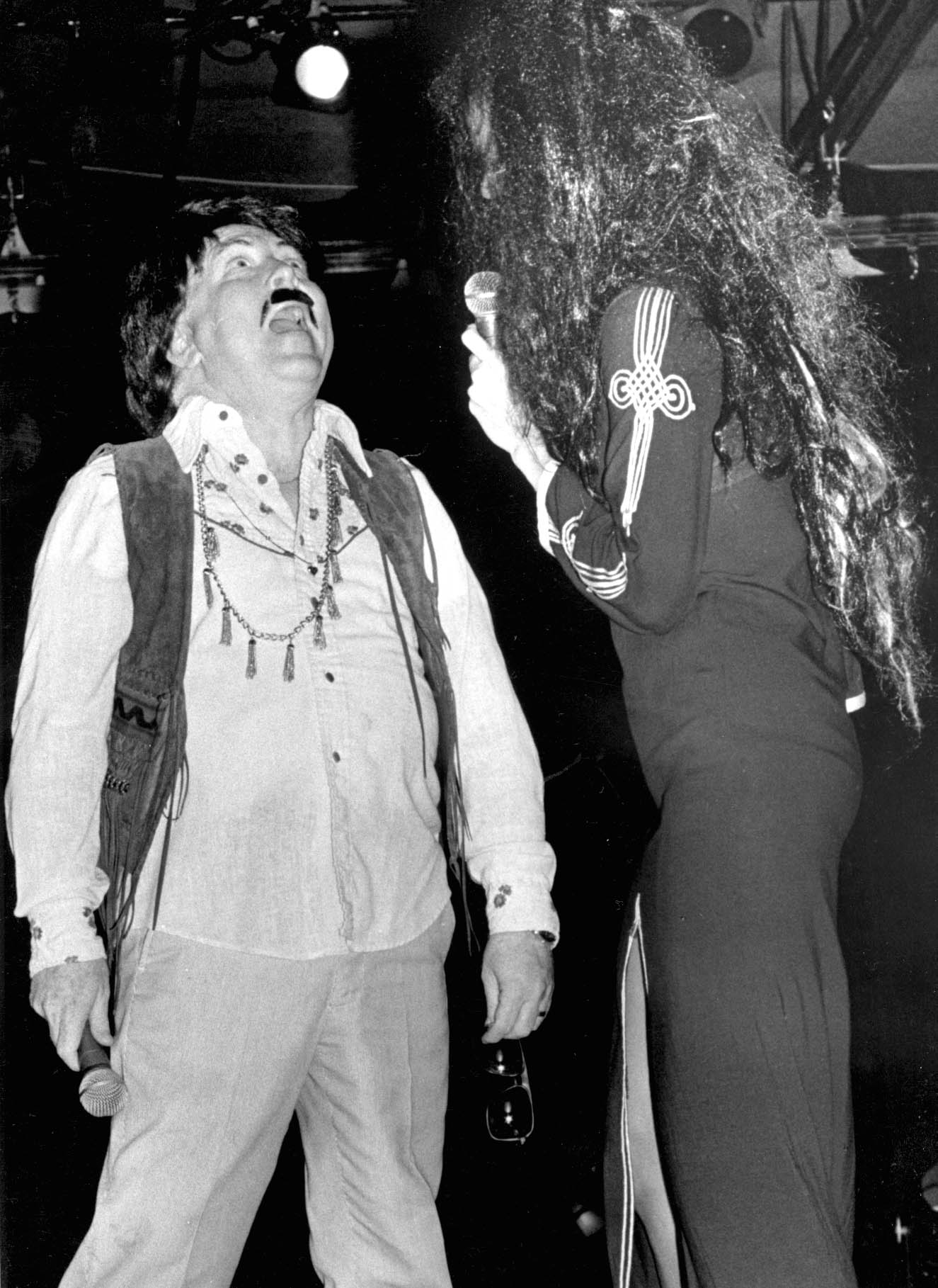 Legislator impersonating Sonny while aide does Cher.