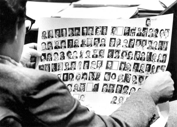 Florida representative legislator Gene Campbell looking at picture chart.