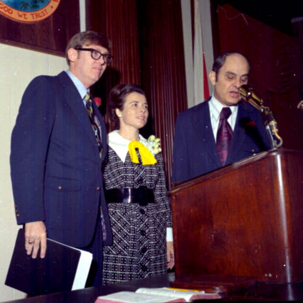 Representative Ralph Turlington speaking at the podium in the Florida House of Representatives.