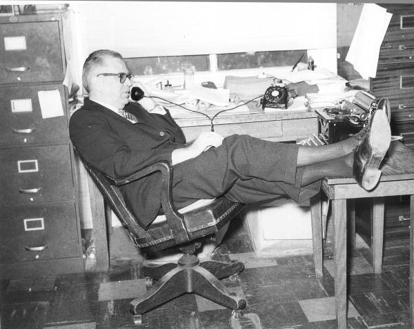 Allen Morris talking on the phone in his office.