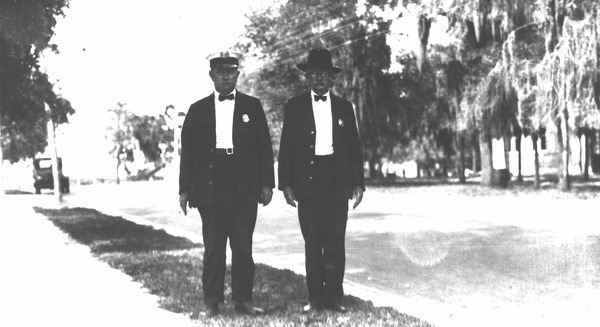 Two men wearing badges