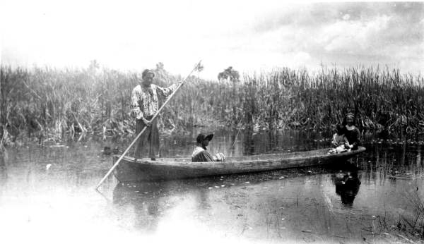 Ingraham Billie moves canoe down Turner River