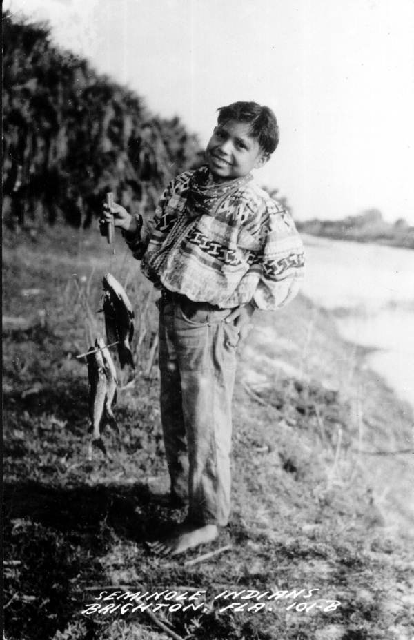 Seminole boy with caught fish - Brighton Reservation, Florida.