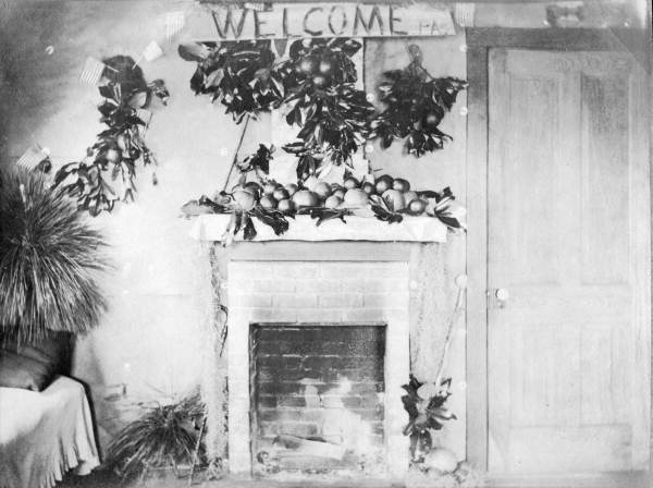 Welcome sign and oranges above fireplace in Florida.