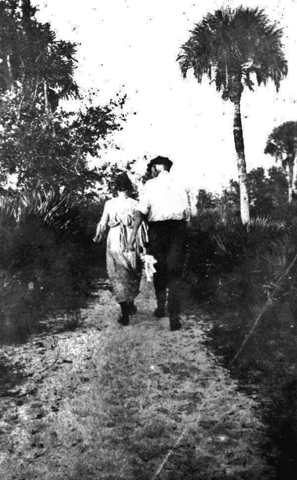 Couple walking down a path in Alva.