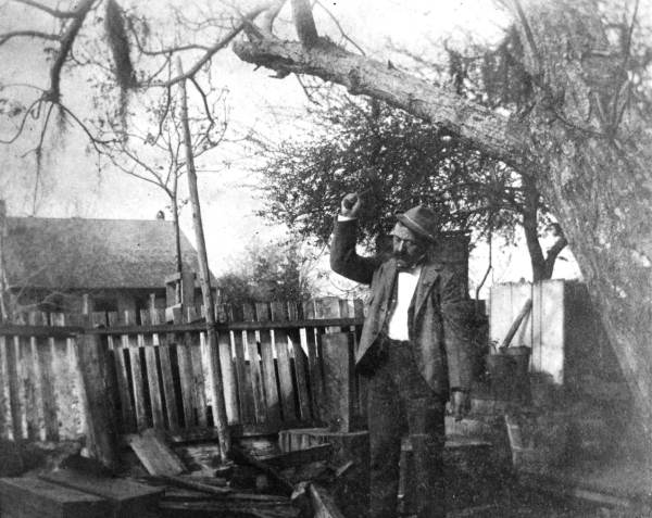 Apalachicola man chopping wood.
