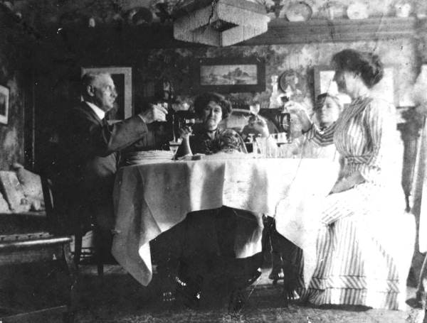 Family toasting each other at a meal.