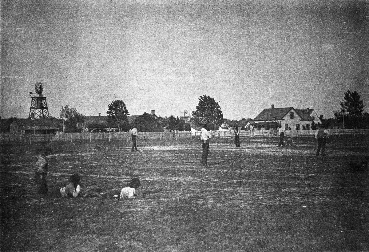 Boys watching baseball game - Apalachicola, Florida.