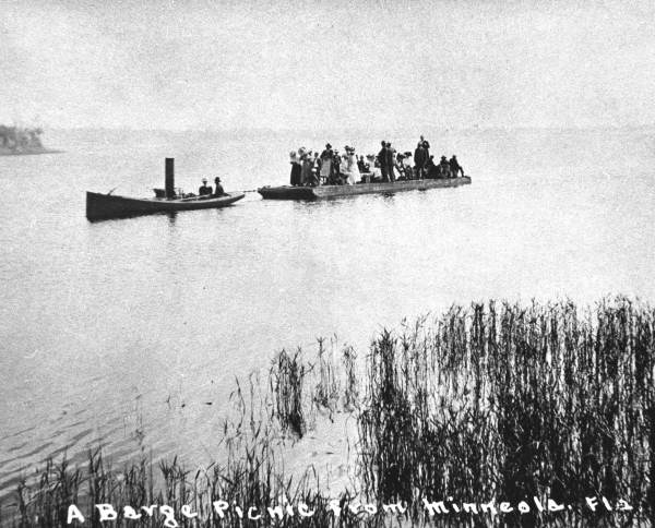 Steamboat pulling barge picnic