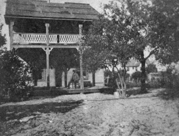 Jules T. Rembert sitting on the porch of his house in Cocoa.