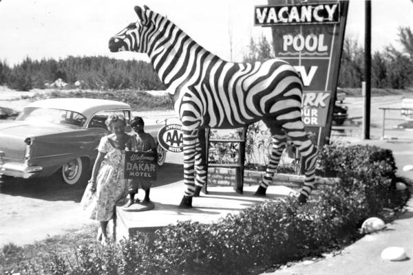 Woman at entrance to the Dakar Motel in Hallandale, Florida.