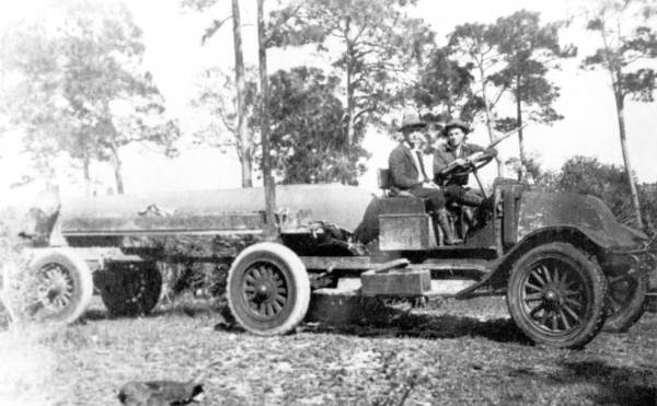 Two men on an early tanker truck